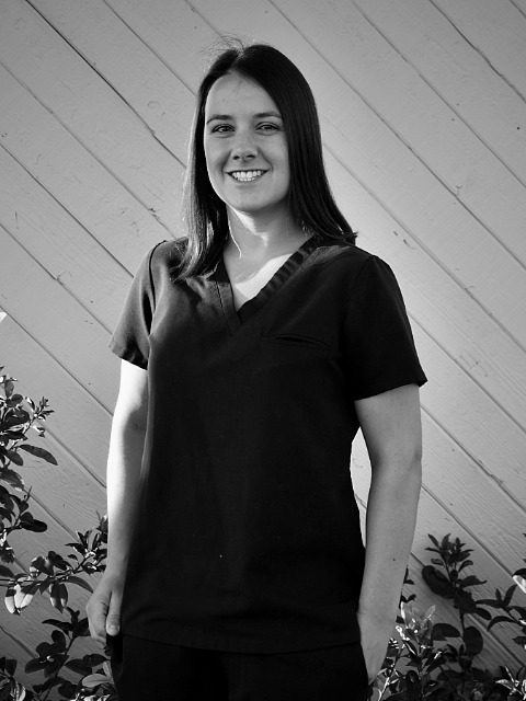 Dr Caley Smith - female vet wearing black scrubs
