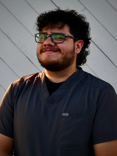 Miguel - male with dark hair and dark rimmed glasses